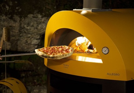 Cooking pizza wood fired pizza oven allegro yellow color 1200x750